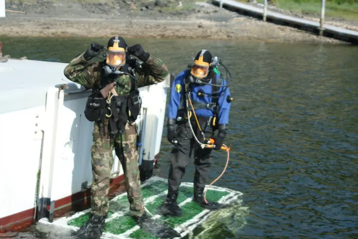 Two divers preparing for surface-supplied underwater work
