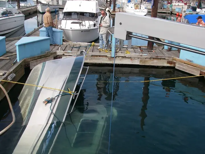 Partially submerged vessel during marina recovery