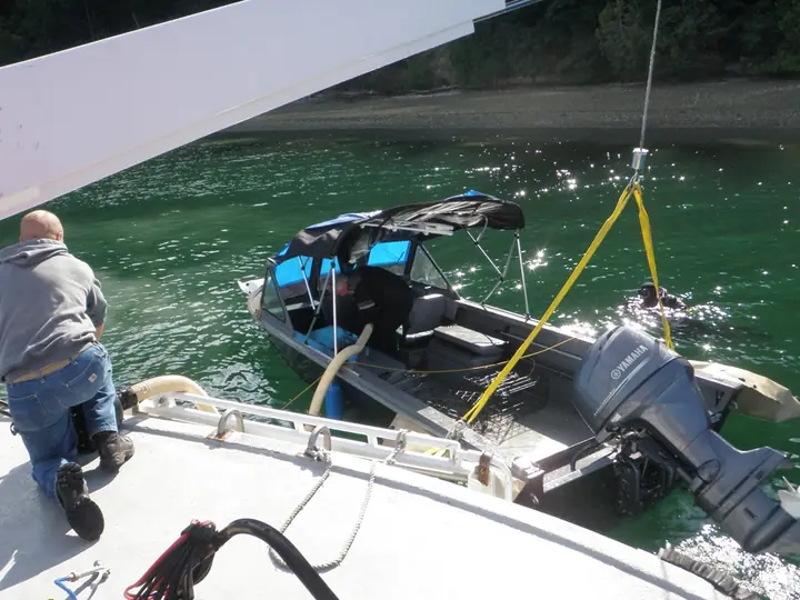 Small boat lift alongside CASCADE